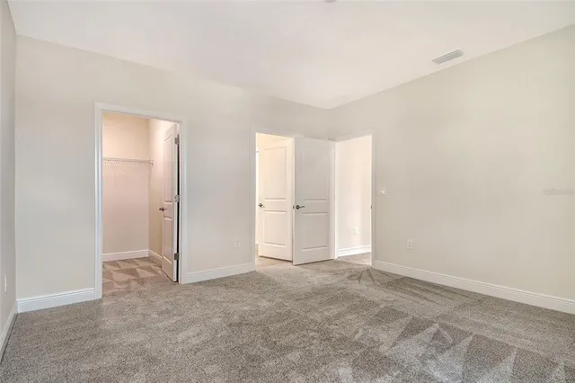a bathroom with a granite countertop sink mirror vanity and toilet