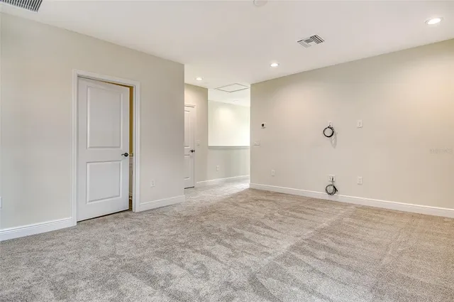 an empty room with closet and a bathroom