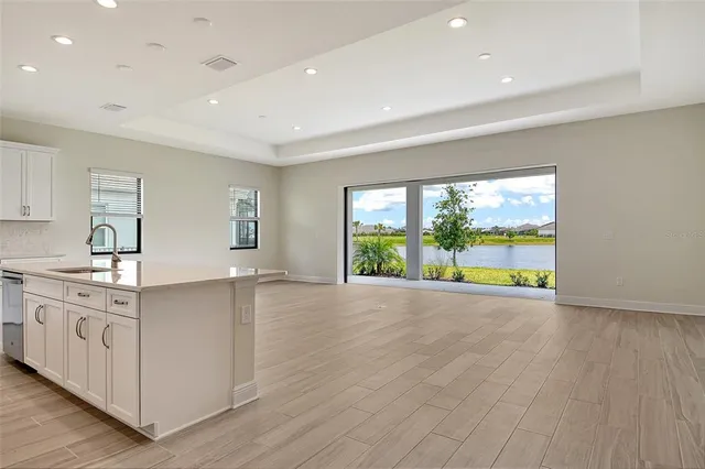 a large kitchen with stainless steel appliances a large window a oven and a large window