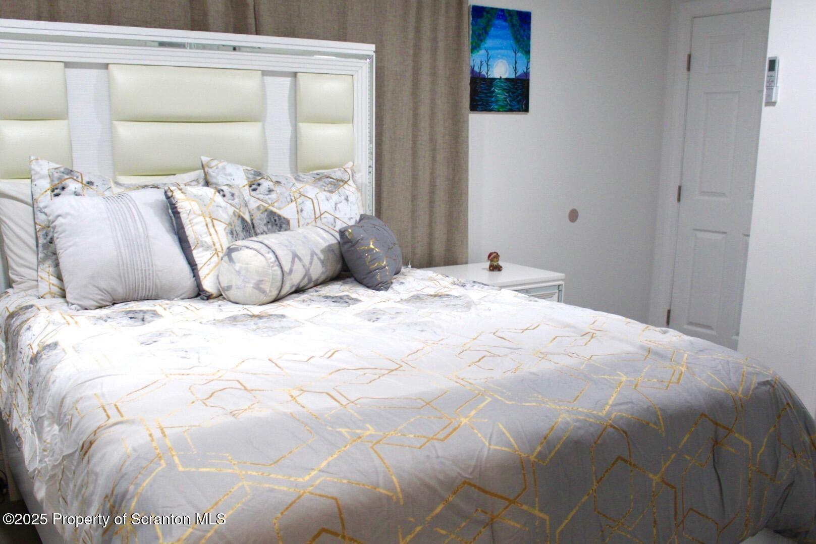 260 East Broad Street Nanticoke, PA 18634 - Photo 12 of 19 a large white bed in a white room