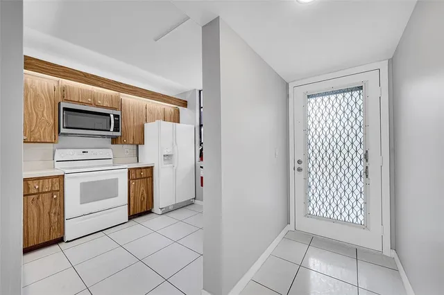 a kitchen with white cabinets and white appliances
