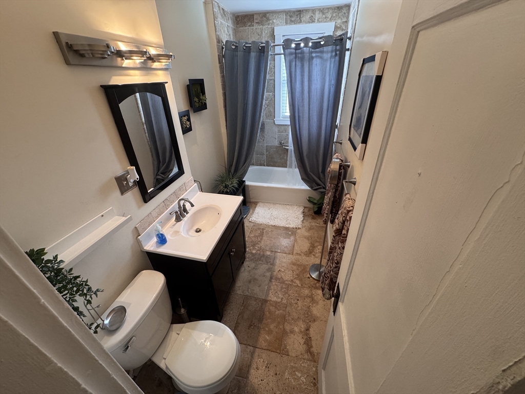 40 Arbutus Street, Unit 3 Boston, MA 02124 - Photo 2 of 8 a bathroom with a toilet sink and mirror