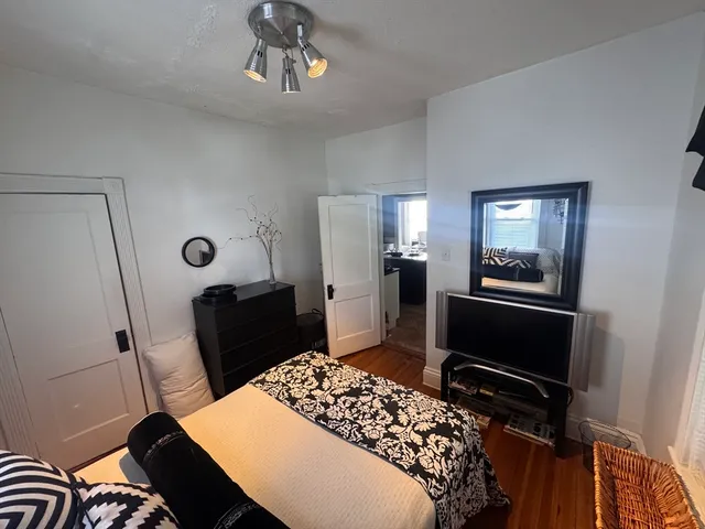 a bedroom with a bed and a mirror