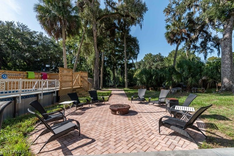 236 Mastadon Drive Inglis, FL 34449 - Photo 12 of 21 a view of backyard with swimming pool and outdoor seating