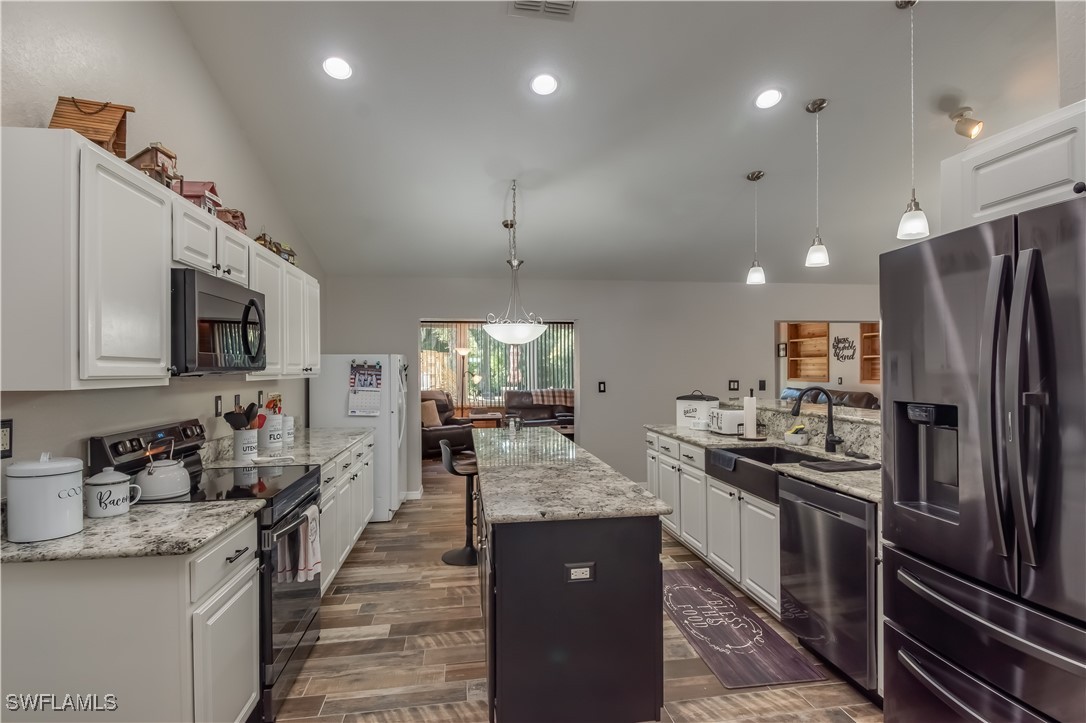 236 Mastadon Drive Inglis, FL 34449 - Photo 15 of 21 a kitchen with stainless steel appliances granite countertop a refrigerator a stove top oven a sink and dishwasher