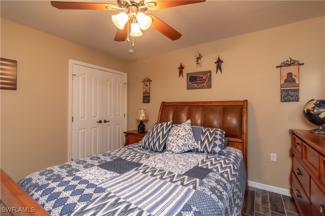 236 Mastadon Drive Inglis, FL 34449 - Photo 18 of 21 a bedroom with a bed and a chandelier