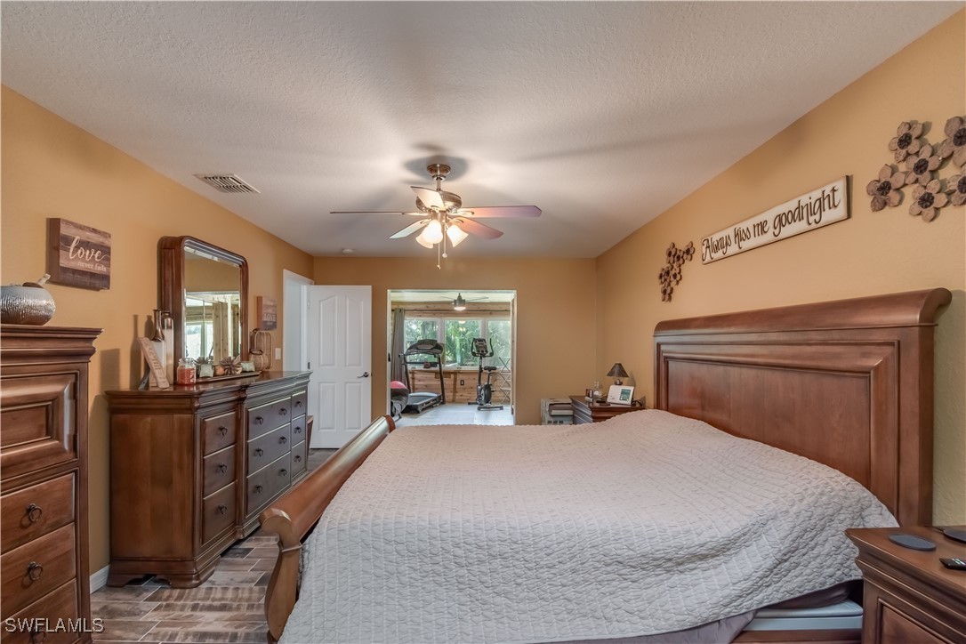 236 Mastadon Drive Inglis, FL 34449 - Photo 20 of 21 a bedroom with a large bed and a chandelier