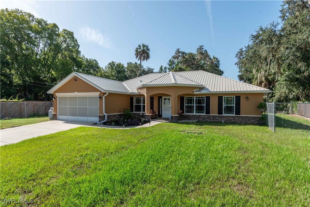 236 Mastadon Drive Inglis, FL 34449 - Photo 2 of 21 a front view of house with yard and green space