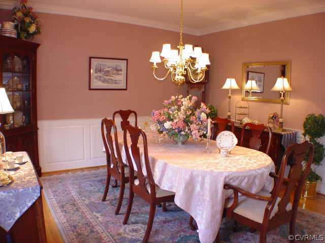 14401 Newgate Road Midlothian, VA 23113 - Photo 4 of 10 a view of a dining room with furniture a chandelier and wooden floor