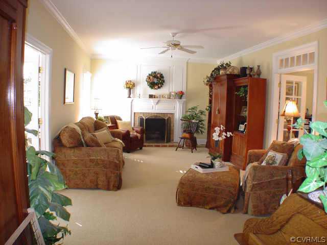 14401 Newgate Road Midlothian, VA 23113 - Photo 5 of 10 a living room with furniture a fireplace and a large window
