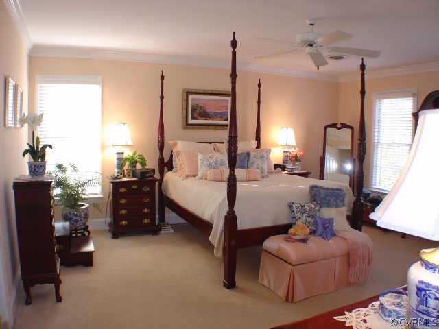 14401 Newgate Road Midlothian, VA 23113 - Photo 8 of 10 a bedroom with furniture and a chandelier