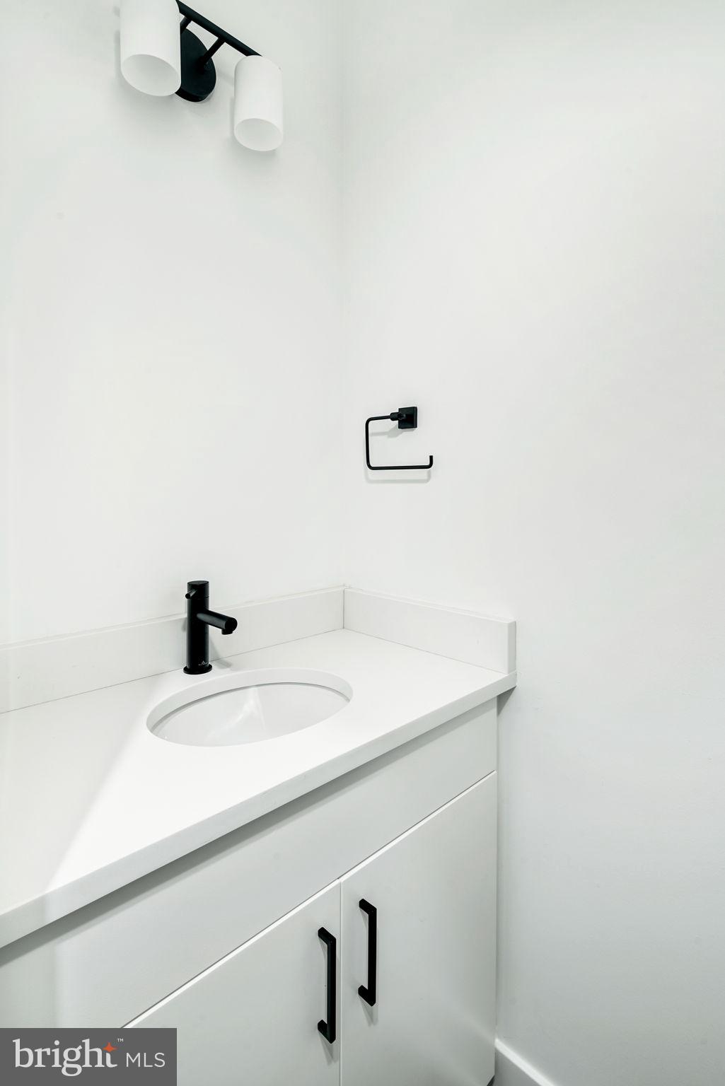 1527-29 Ridge Avenue, Unit 3A Philadelphia, PA 19130 - Photo 26 of 33 a bathroom with a sink and a mirror