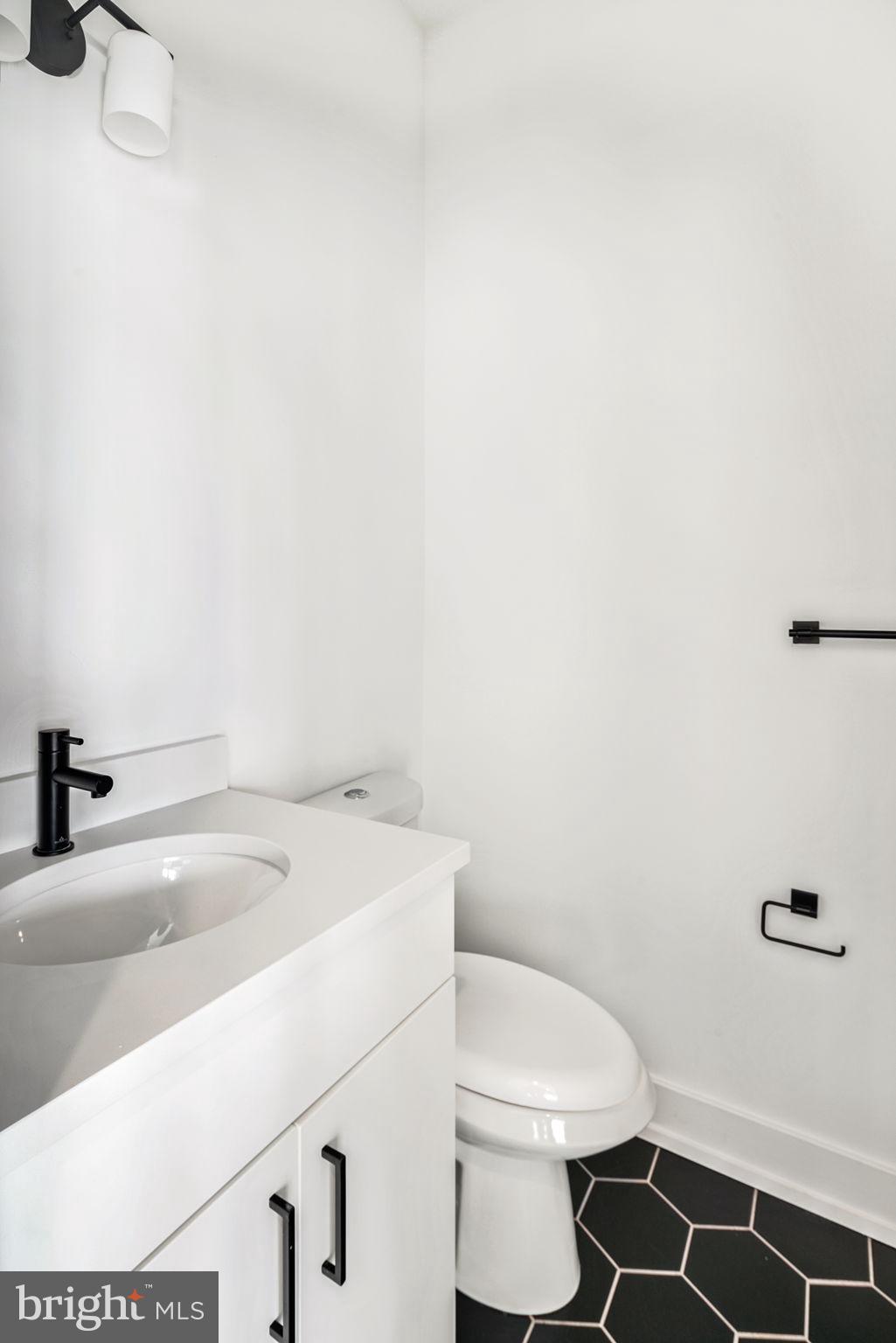 1527-29 Ridge Avenue, Unit 3A Philadelphia, PA 19130 - Photo 27 of 33 a bathroom with a sink a toilet and a mirror