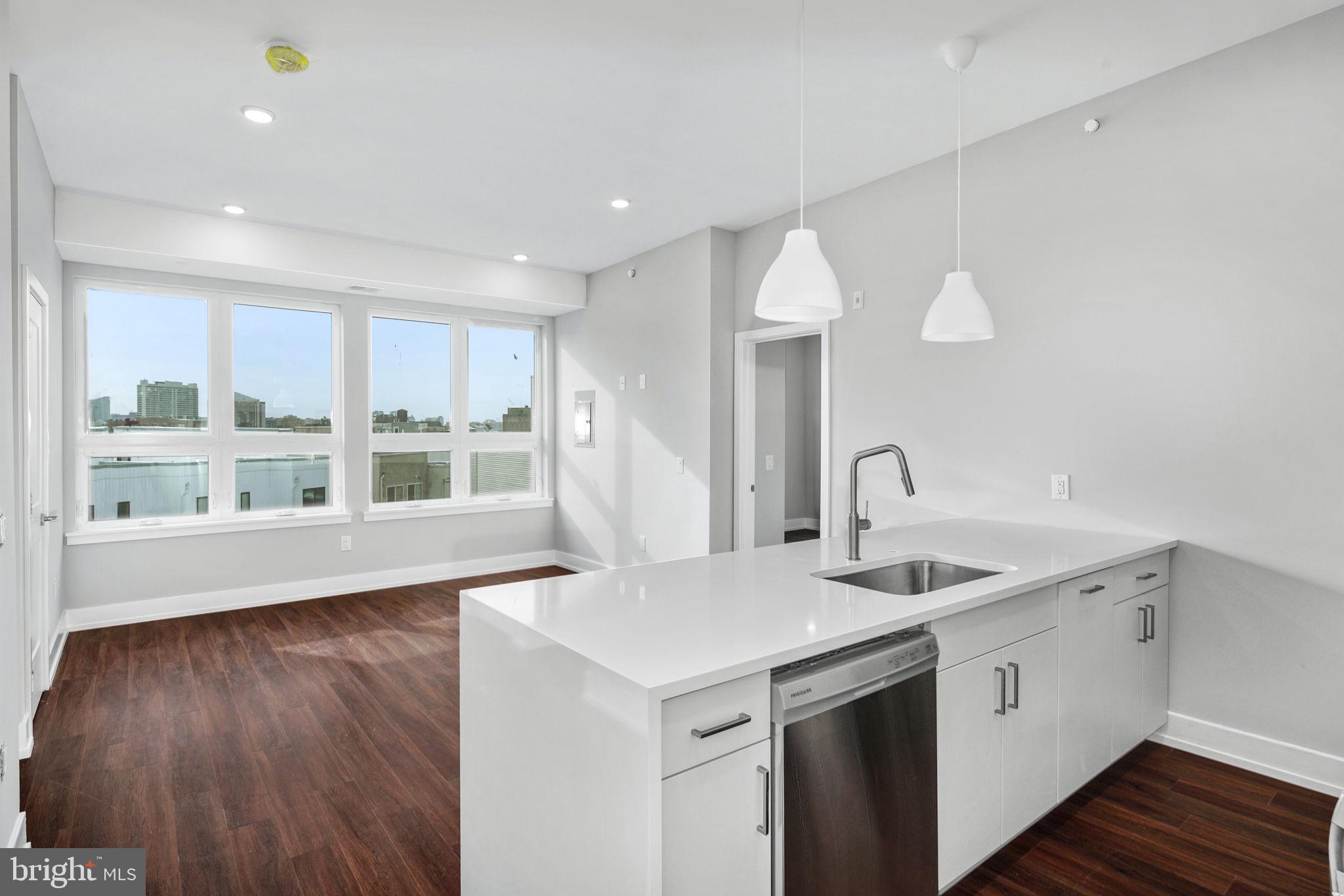 1527-29 Ridge Avenue, Unit 3A Philadelphia, PA 19130 - Photo 5 of 33 a kitchen with a sink and wooden floor