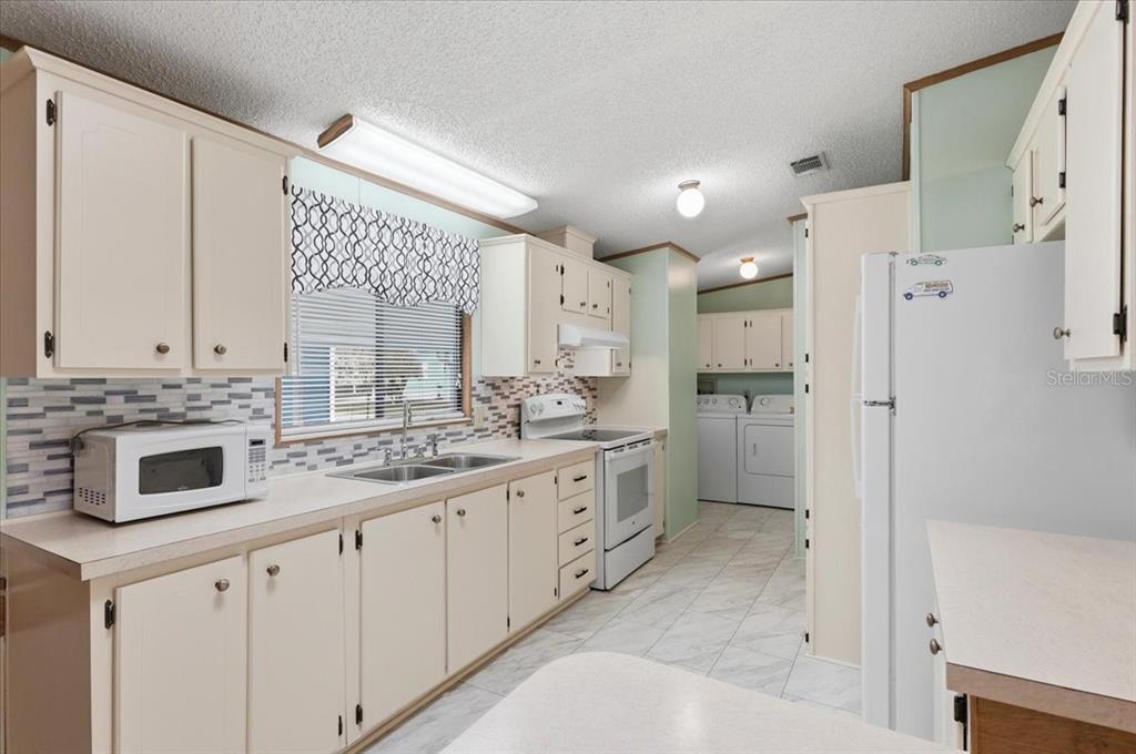 1798 Fox Hill Drive Lakeland, FL 33810 - Photo 12 of 41 a large white kitchen with stainless steel appliances