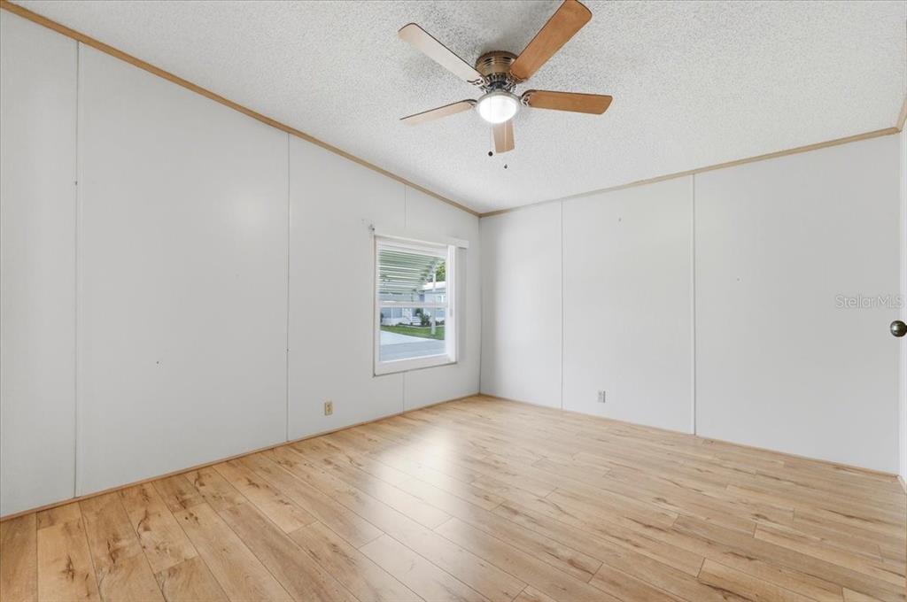 1798 Fox Hill Drive Lakeland, FL 33810 - Photo 14 of 41 an empty room with wooden floor and ceiling fan