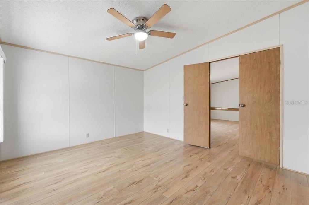 1798 Fox Hill Drive Lakeland, FL 33810 - Photo 15 of 41 an empty room with wooden floor and a ceiling fan