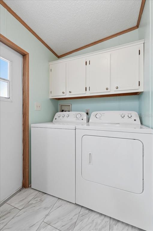 1798 Fox Hill Drive Lakeland, FL 33810 - Photo 25 of 41 a view of washer and dryer with cabinet