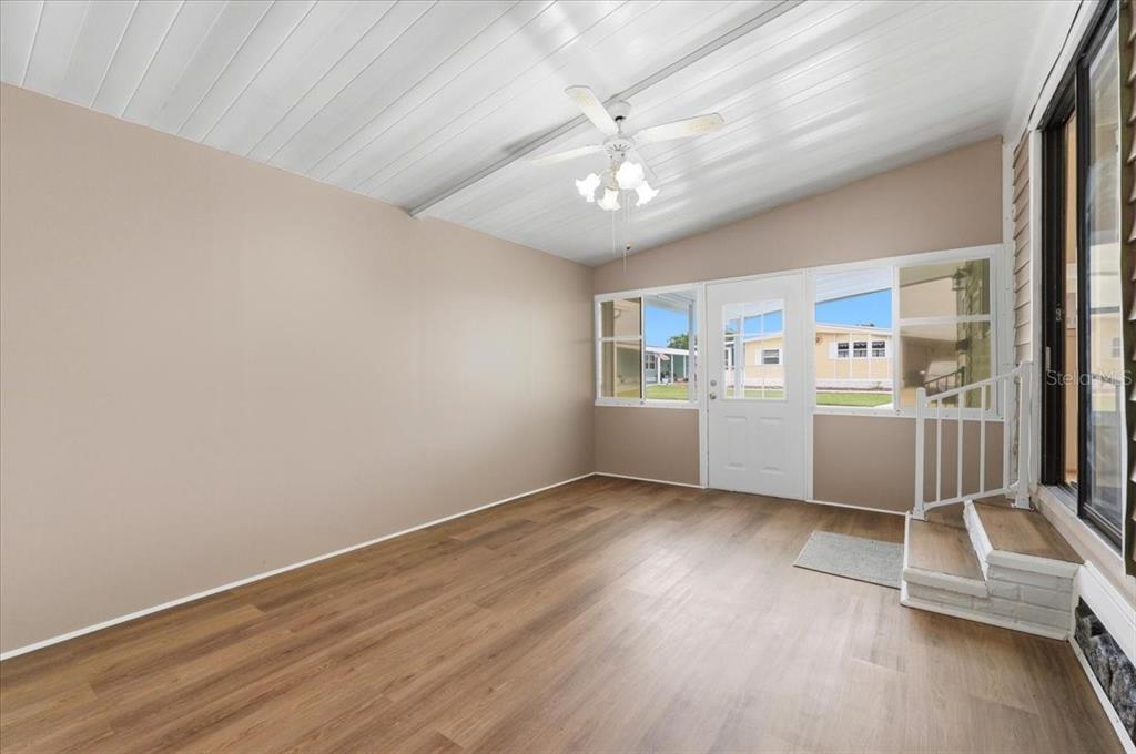 1798 Fox Hill Drive Lakeland, FL 33810 - Photo 7 of 41 a view of a livingroom with furniture wooden floor a ceiling fan and windows