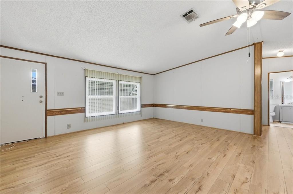 1798 Fox Hill Drive Lakeland, FL 33810 - Photo 9 of 41 an empty room with wooden floor fan and windows