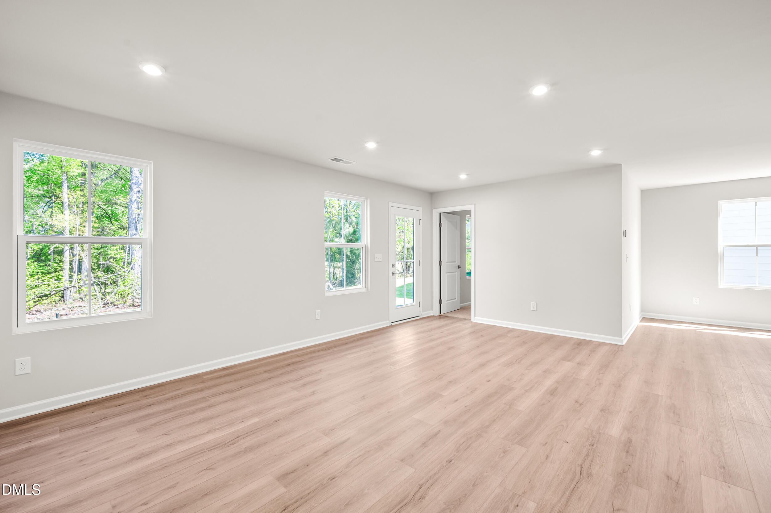 129 Cavalier Rider Run Wendell, NC 27591 - Photo 11 of 38 an empty room with wooden floor and windows