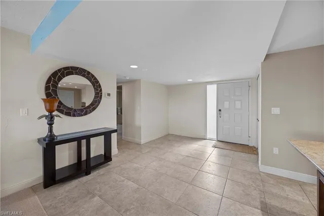 a view of a livingroom with furniture and mirror