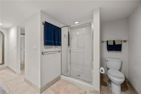 a bathroom with a toilet a sink and shower