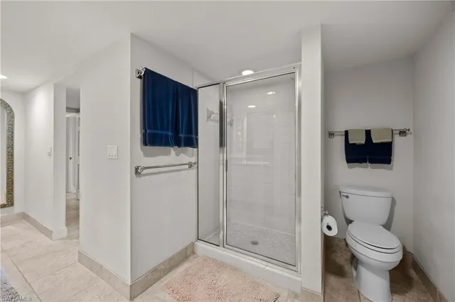 a bathroom with a toilet a sink and shower