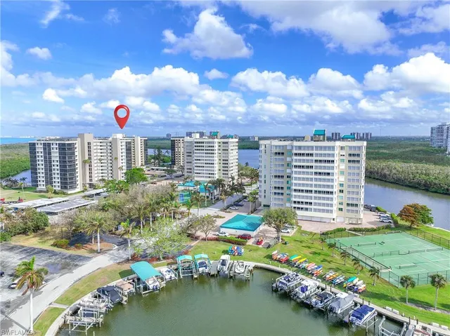 an aerial view of a swimming pool with outdoor seating and city view