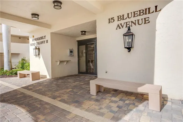 a view of a hallway to a room with window and glass door