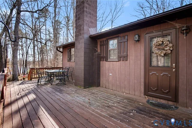 a view of backyard with a deck and wooden floor