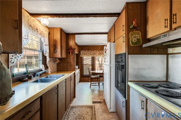 a kitchen with stainless steel appliances granite countertop a stove and a sink