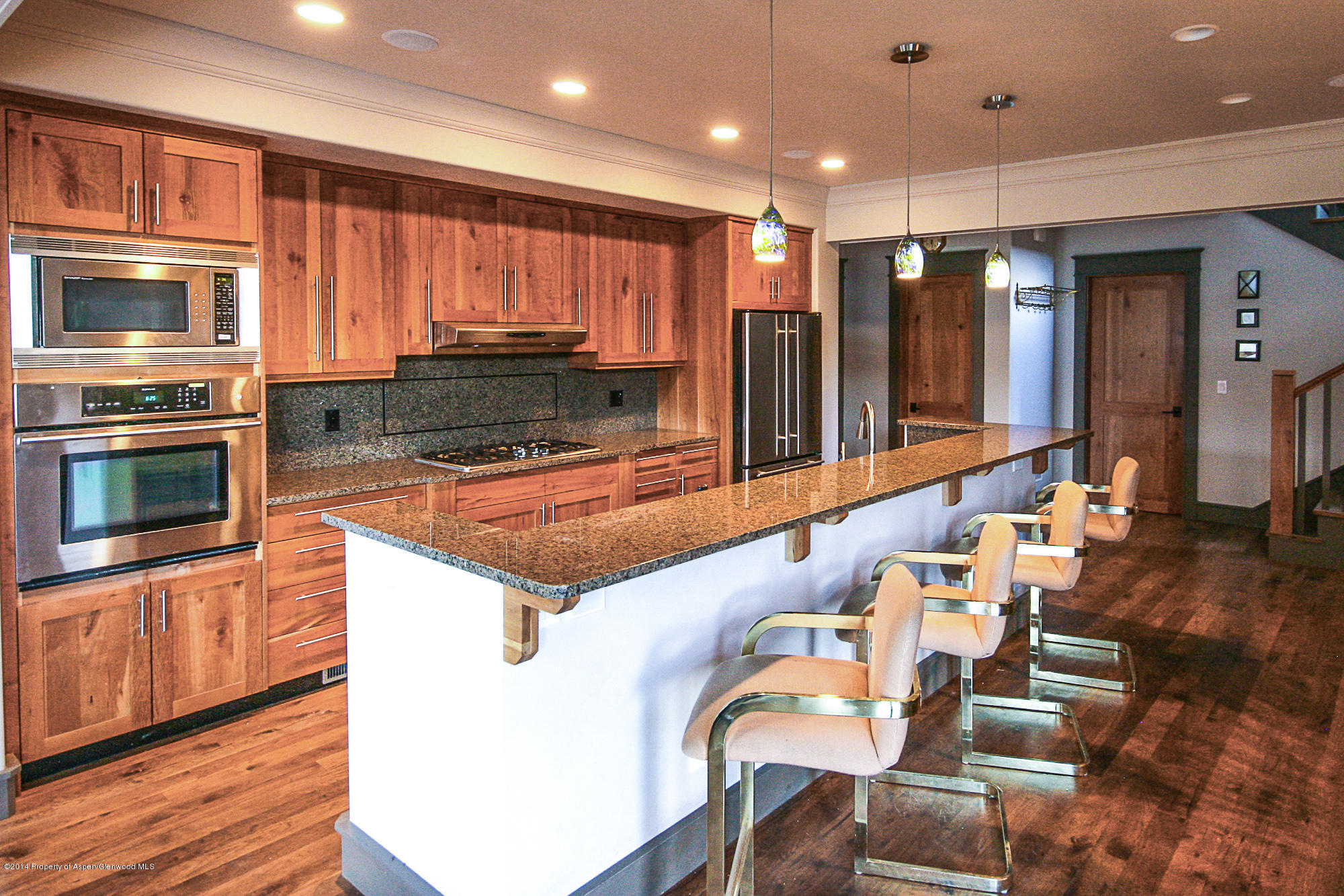 210 Diamond A Ranch Road Carbondale, CO 81623 - Photo 4 of 14 a kitchen with stainless steel appliances kitchen island granite countertop a stove a sink and a microwave