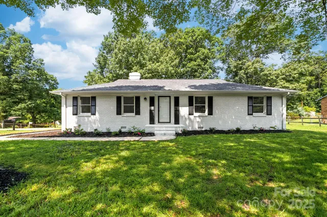 a front view of house with yard and green space