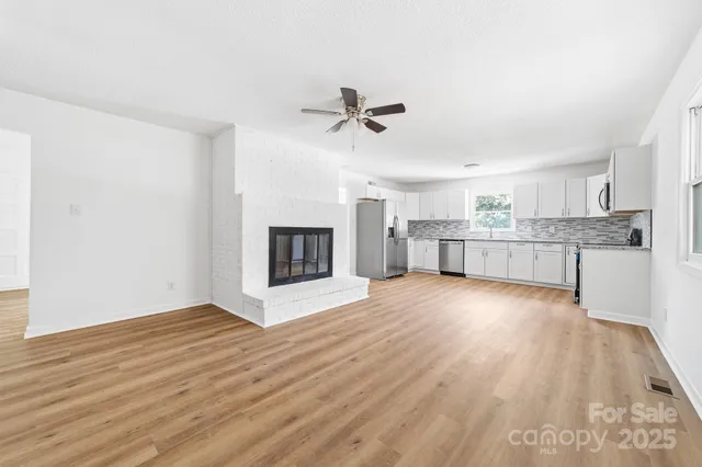 a view of a kitchen with a sink and a fireplace