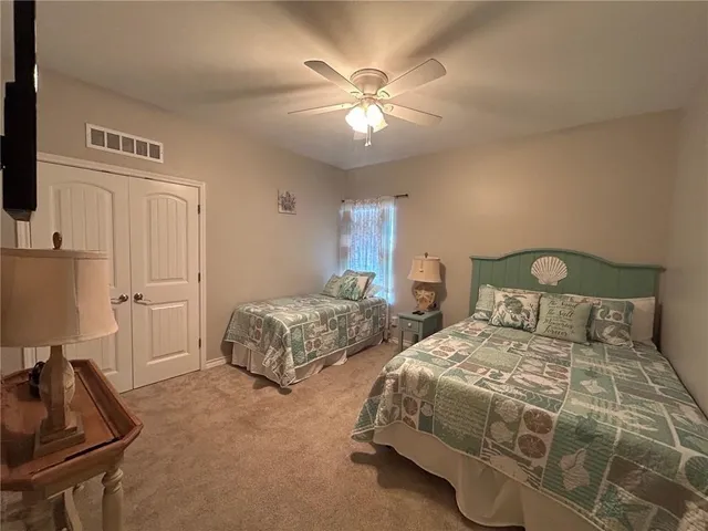 a bedroom with two beds and a chandelier