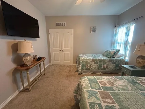 a bedroom with a bed and flat screen tv