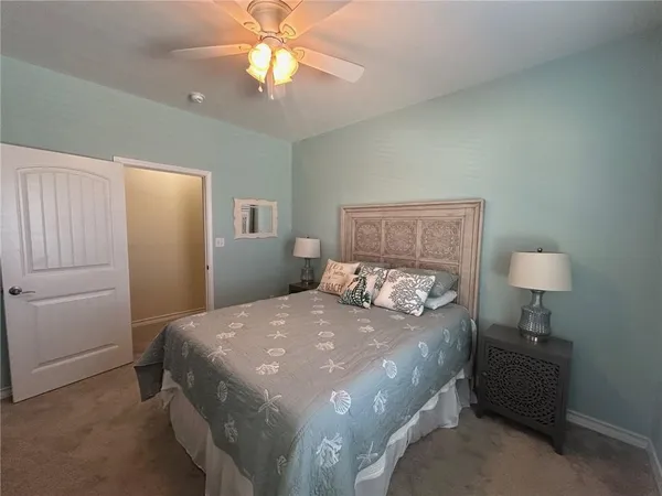 a bedroom with a bed and a lamp