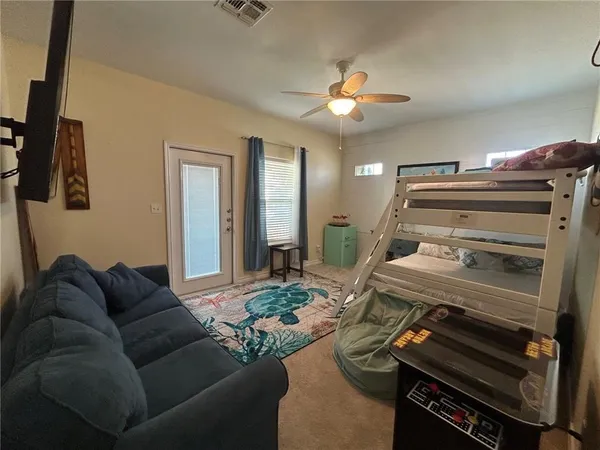 a living room with furniture and a piano