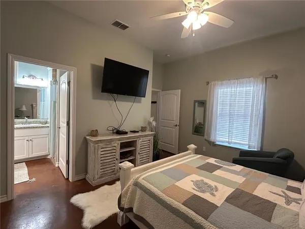 a bedroom with a bed and a flat screen tv