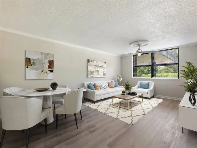 a living room with furniture a large window and a table
