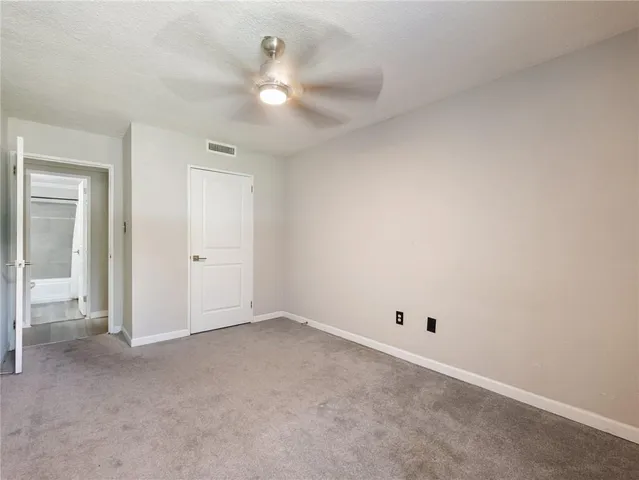 a view of an empty room with a fan