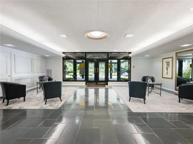 a view of a lobby with furniture and floor to ceiling window