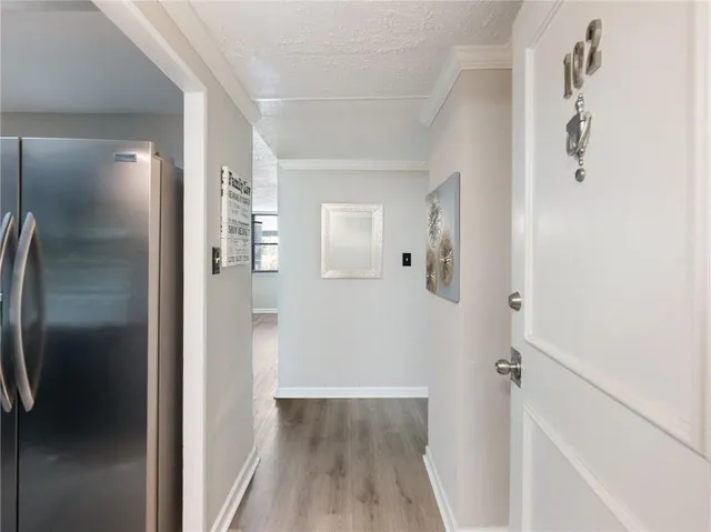 a view of a hallway with wooden floor