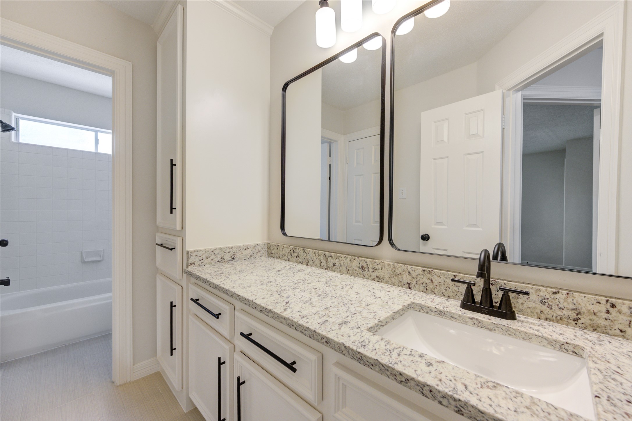 17318 Bonnard Circle Spring, TX 77379 - Photo 37 of 45 Bathroom 3 has a new granite countertops, new undermount sink and faucet, and 2 new mirrors, light fixture, cabinet pulls, toilet, and 24" tile flooring. This bathroom also connect to the hallway and to bedroom 5, making bedroom 5 a possible upstairs primary bedroom.