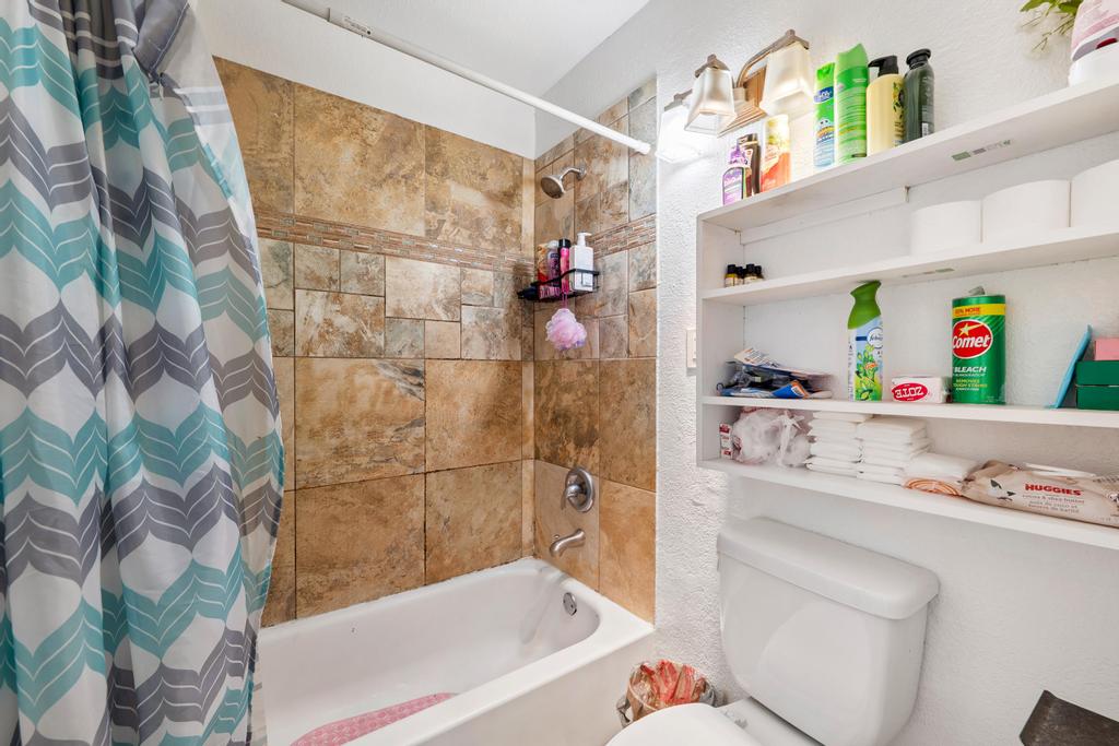 5309 Prock Lane Austin, TX 78721 - Photo 15 of 19 Bathroom featuring toilet and shower / bath combo