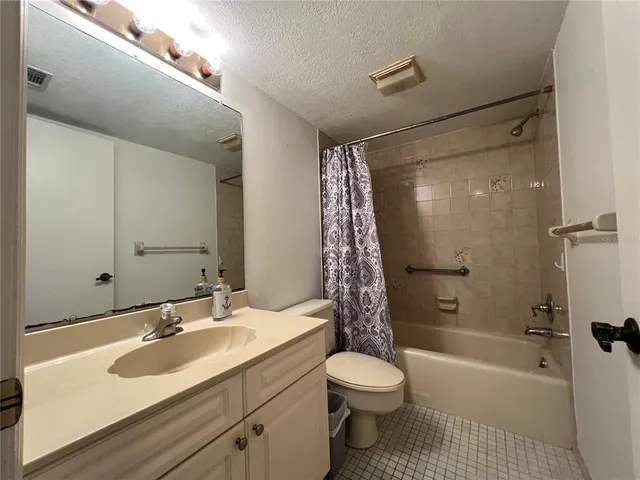 a bathroom with a sink toilet tub and shower