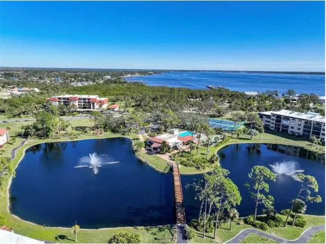 a view of a balcony with dining table & chairs