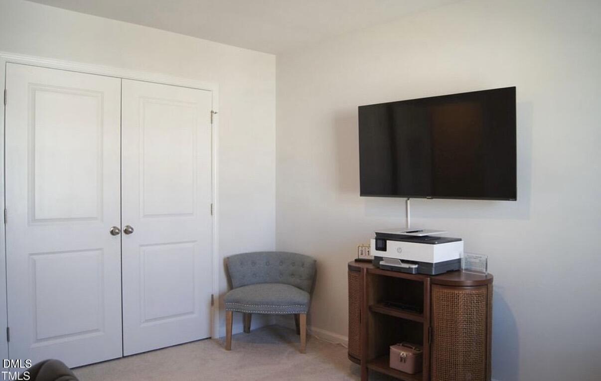 5006 Tura Street Raleigh, NC 27610 - Photo 22 of 32 a living room with furniture and a flat screen tv