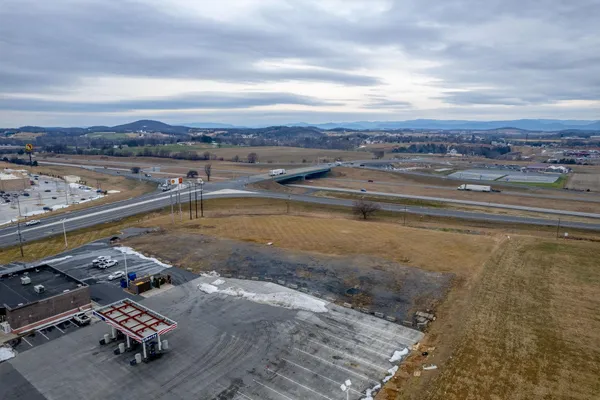 an aerial view of a house with a swimming pool an outdoor seating yard and mountain view in back